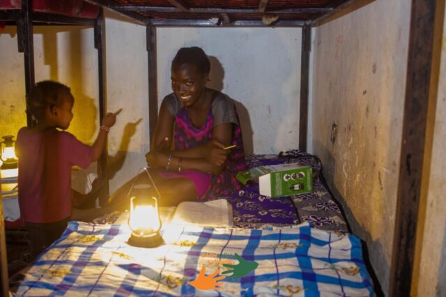 the girl use solar candle light to read the book