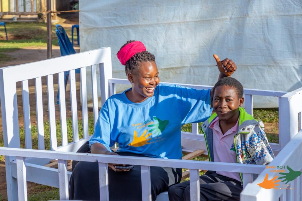 A volunteer shares in the joy — thumbs up for the community