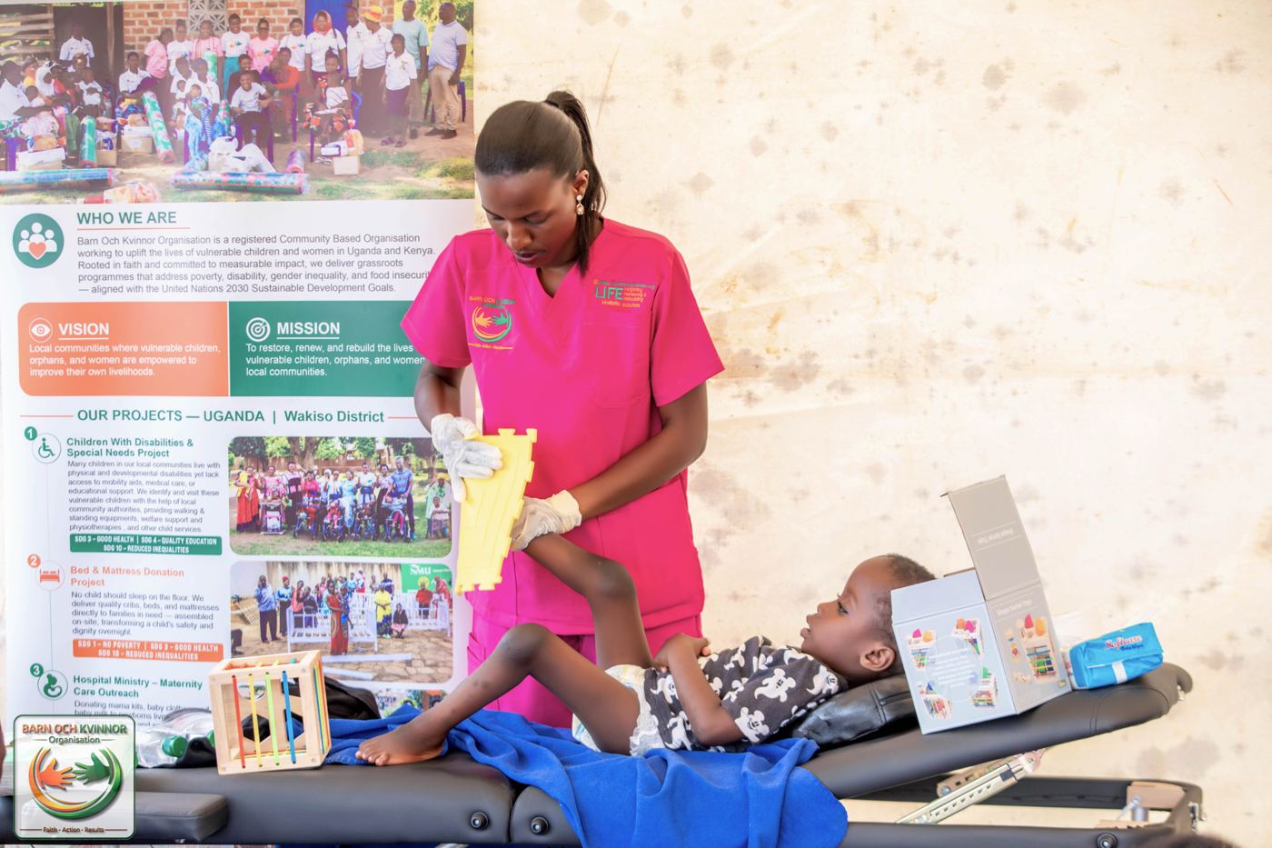 A BOK physiotherapist guides a child through a therapeutic exercise.