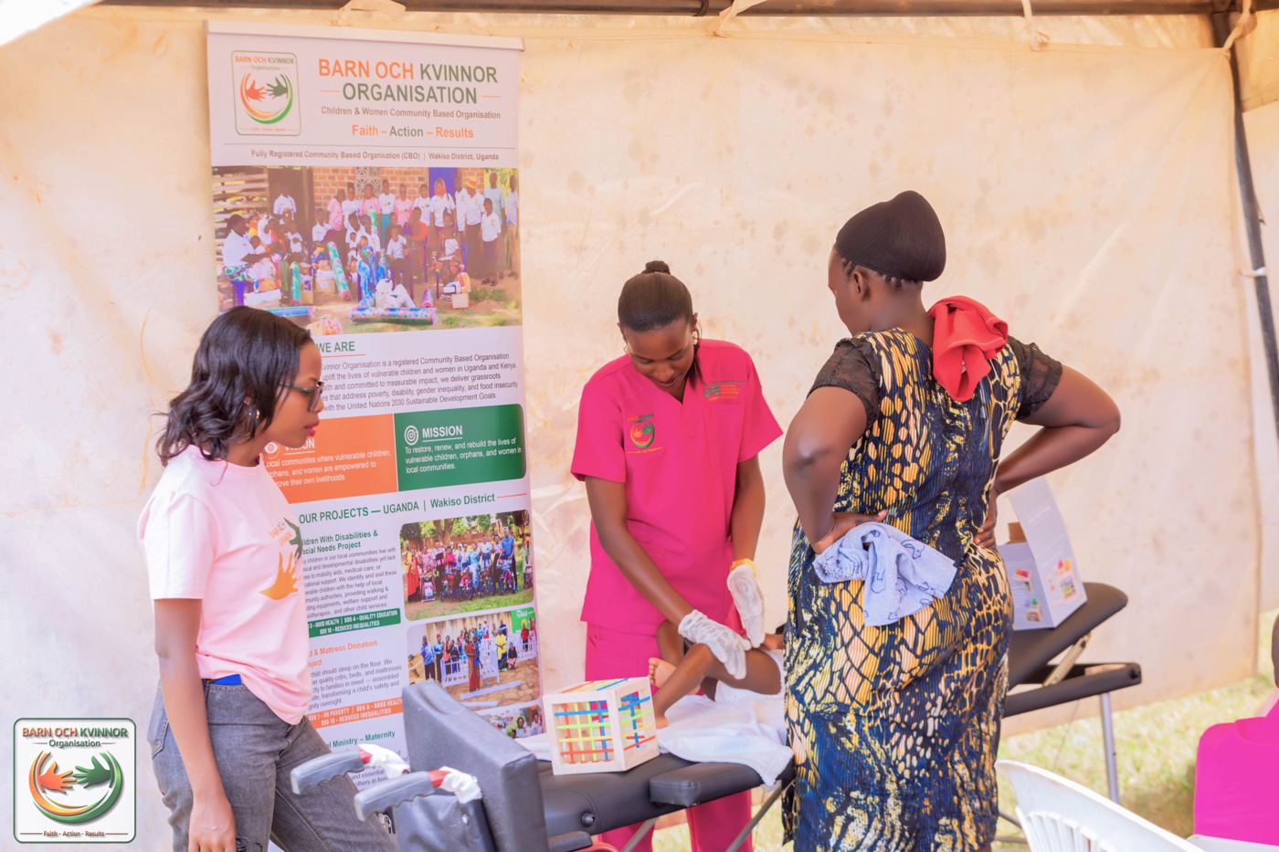 Physiotherapist Babra Komuhangi assesses a young child at the outreach tent, guiding the mother through correct positioning and home-based care.
