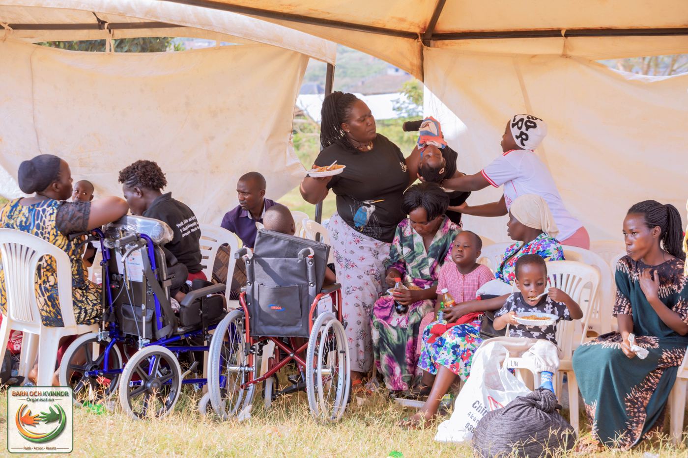 Families share a meal together at the outreach tent.
