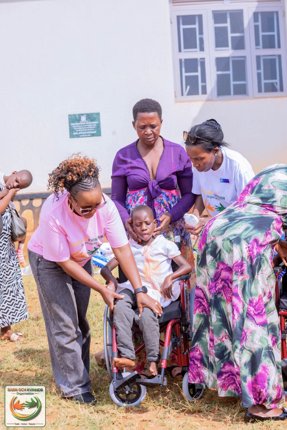 A BOK volunteer helps fit a child comfortably into a wheelchair.
