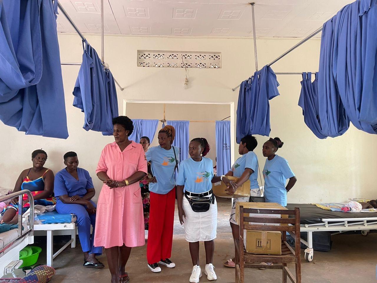 Mothers and a midwife talking on a maternity ward