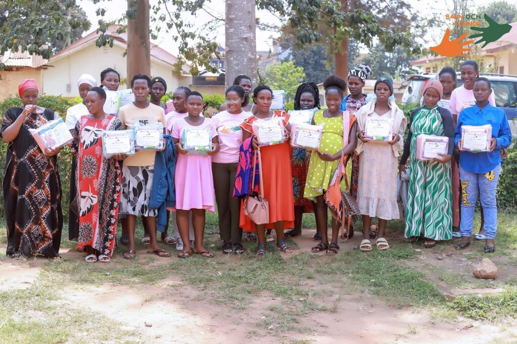 A line of mothers holding their Mama Kits outdoors
