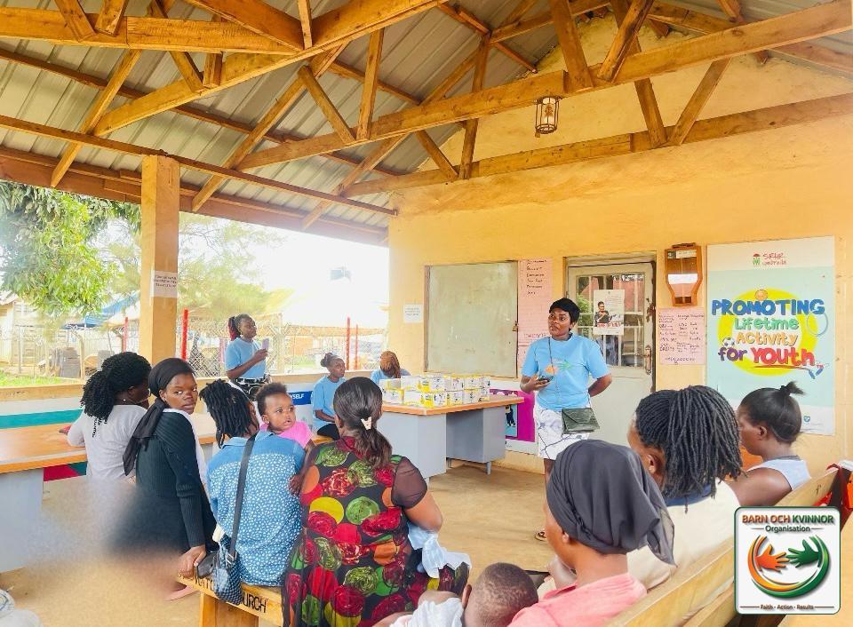 A group session for mothers in the health centre hall