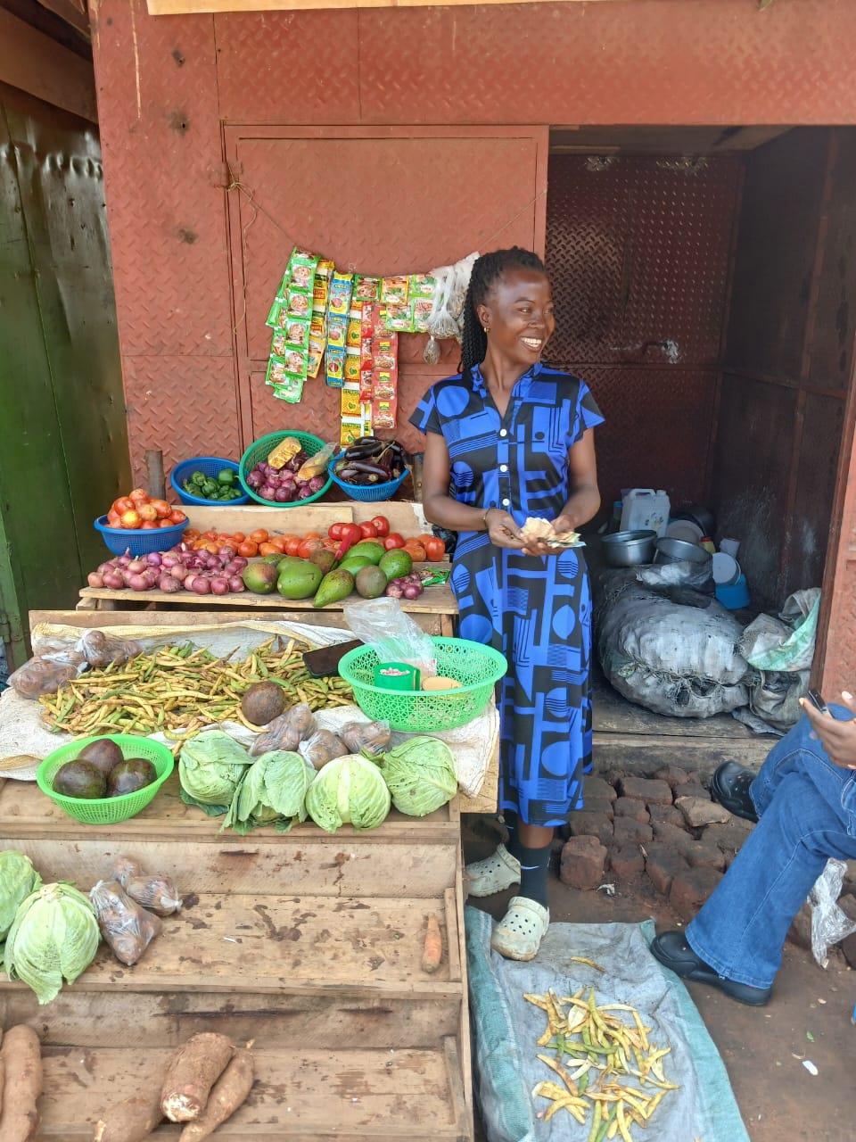 Mama Jennifer smiling at her produce stall